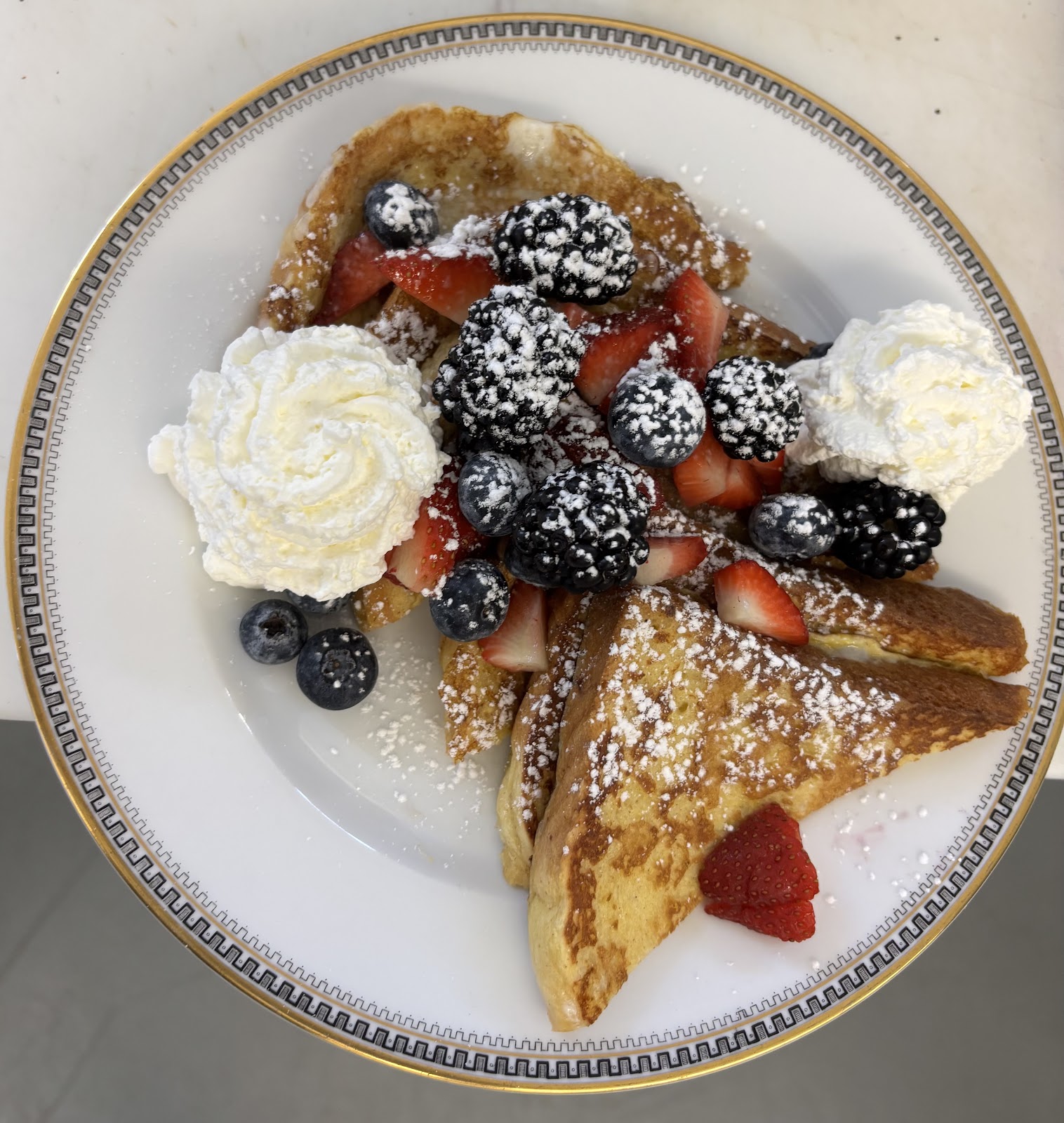 Breakfast plate with berries and whipped cream