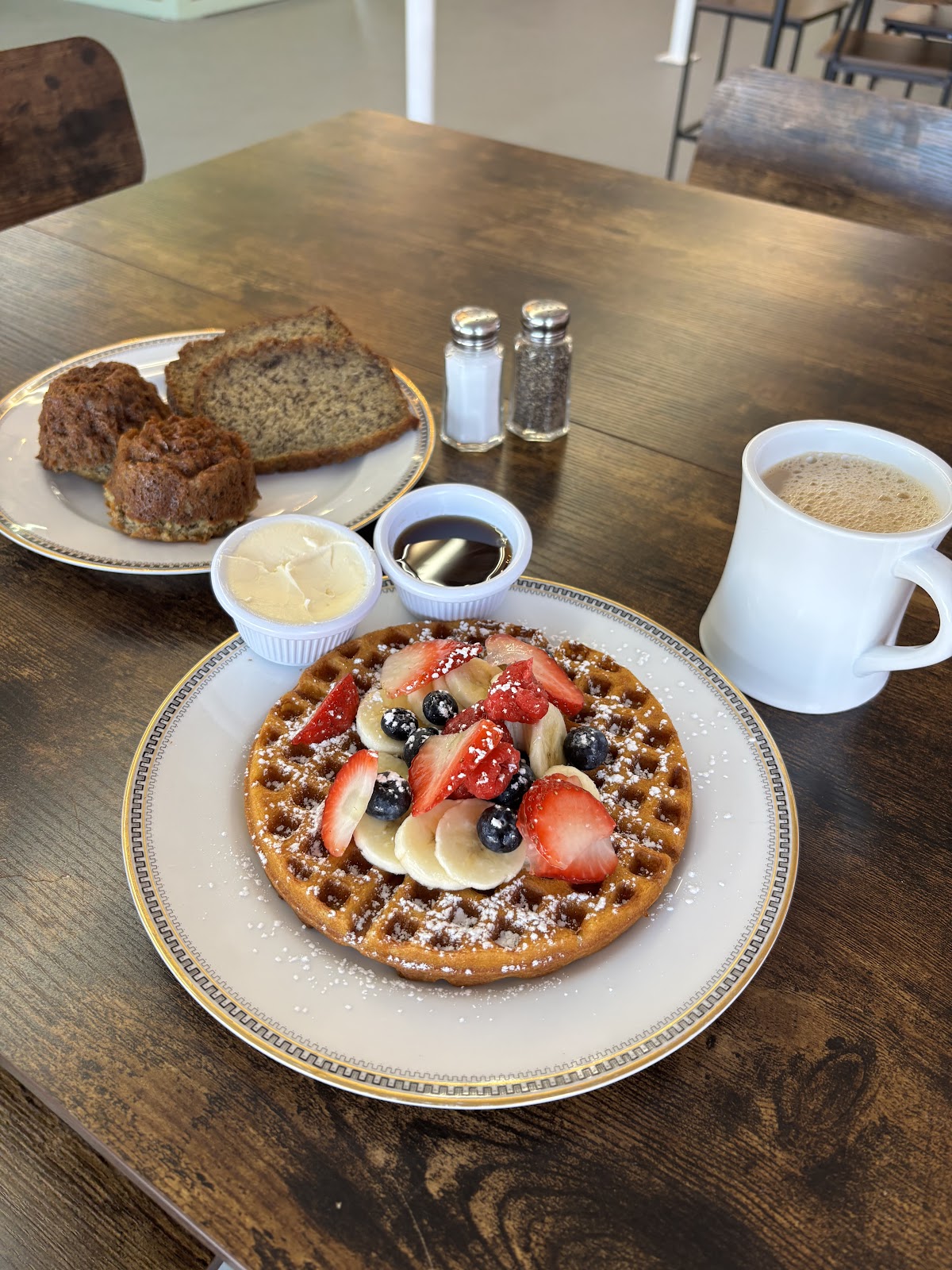 Plated cafe food beside a cup of coffee